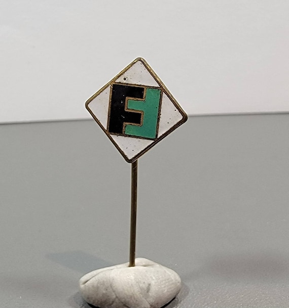 Lapel pin FF initials logo white green enamel tie pin