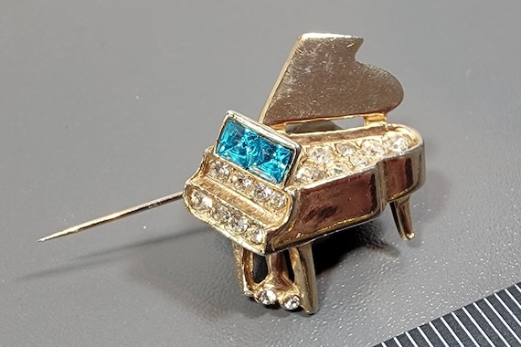 piano brooch gold tone metal with blue and clear rhinestones accents