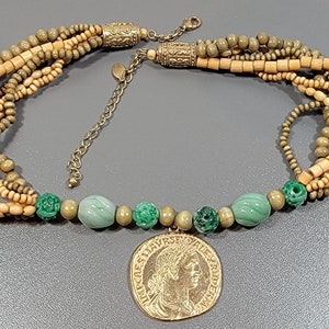 coin pendant necklace multi strands of beads green and gold