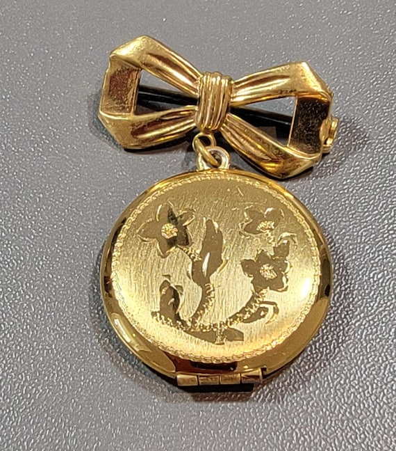 Floral brooch engraved locket bow brooch gold tone