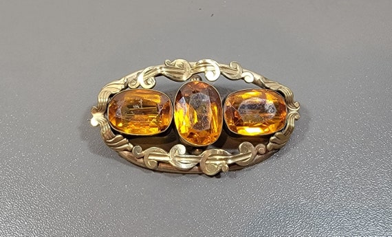 Victorian brooch rolled gold November birthstone topaz glass stones surface wear