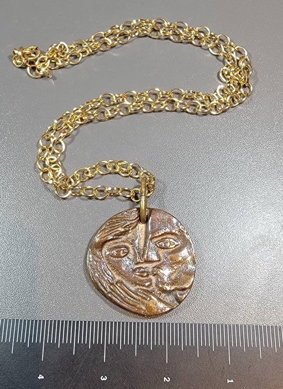 brutalist pendant big heavy and bold lovers kissing
