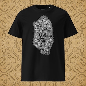 May include: A black short-sleeved t-shirt featuring a white graphic print of a stylized jaguar face composed of intricate, flowing line patterns. The design is centered on the chest, showcasing a detailed feline head with symmetrical markings.