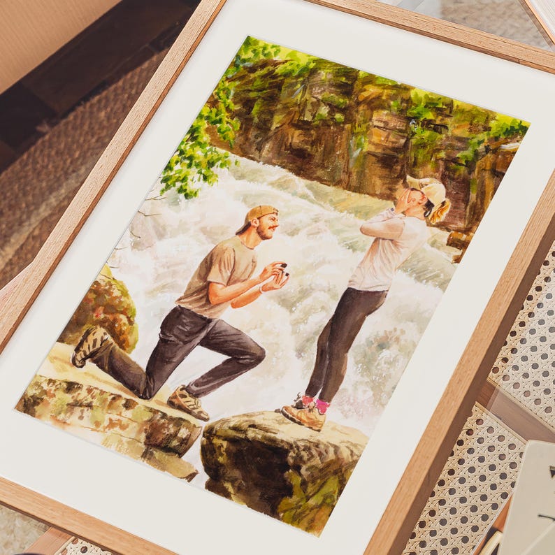 May include: Watercolor painting of a marriage proposal scene. A man kneels on a rock, presenting a ring to a woman standing nearby. The background features a waterfall and lush greenery, framed in a wooden frame.