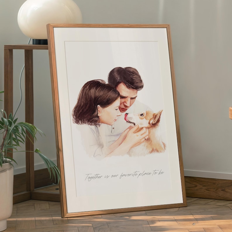 May include: A framed watercolour print showing a couple and a dog. The artwork is in a wooden frame and includes the text "Together is our favourite place to be". The print has a white border and is displayed indoors.