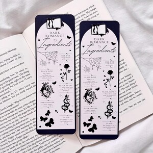 May include: Two black bookmark designs with a dark romance theme. Each bookmark features a black heart, black rose, black dagger, black butterflies, and a spider web with the text "Dark Romance Ingredients".