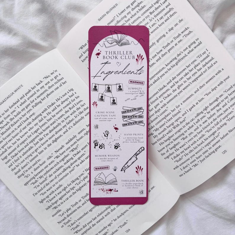 May include: A pink bookmark with a white outline of a book and the words "Thriller Book Club Ingredients" in a white heart. The bookmark has a list of "Ingredients" for a murder mystery, including crime scene caution tape, hand prints, a murder weapon, and a suspect's warning.