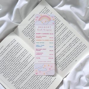 May include: A bookmark in the shape of a receipt, with the words "Receipt Book Tropes." It has a rainbow, clouds, and hearts design. The receipt lists book titles and prices, with a total of £70.