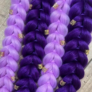 May include: A white ceramic mug with a black handle and the text "But First, Coffee" in a bold, black font. The mug is filled with a dark liquid, likely coffee, and sits on a light-colored surface.