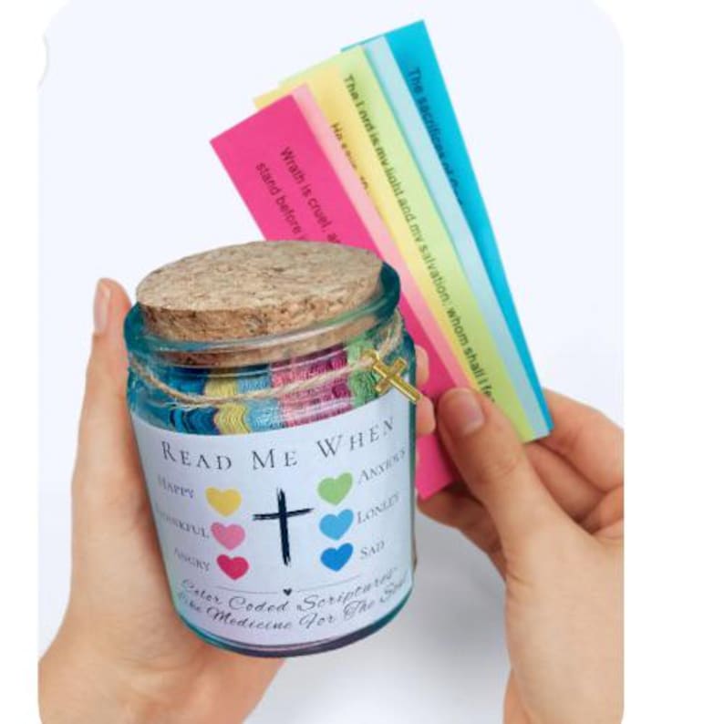 May include: A glass jar with a cork lid, labeled "READ ME WHEN" with emotions like "Happy" and "Sad." It contains color-coded scripture cards and a small gold cross charm. The jar is decorated with colorful twine.