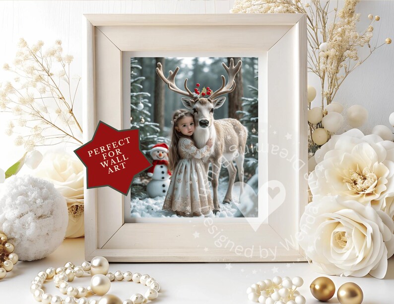 May include: A framed print featuring a young girl embracing a deer in a snowy forest. The deer wears a festive red and green antler decoration. A snowman is visible in the background. The frame is white, and a red star-shaped sticker reads "PERFECT FOR WALL ART."