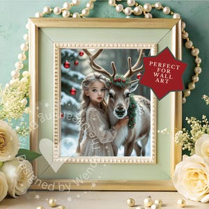 May include: A framed print featuring a young girl with a reindeer in a winter scene. The girl wears a light-colored dress and embraces the reindeer, which has a wreath around its neck. The frame is light green with gold accents.