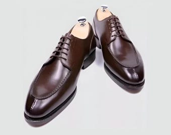 Luxury brown leather brogues, classic lace-up dress shoes.