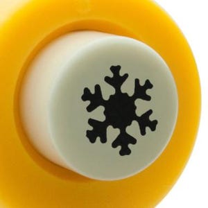 Könnte beinhalten: Ein gelber und weißer Schneeflocken-Stanz mit einem schwarzen Schneeflocken-Design.