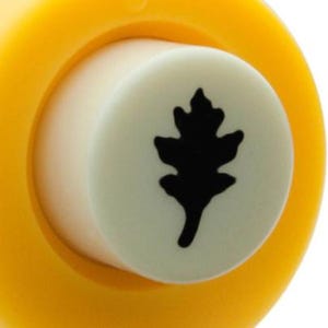 May include: Yellow and white craft punch with a black silhouette of an oak leaf.