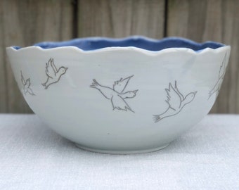 Large porcelain bowl with inlaid flying birds and clear and blue glazes