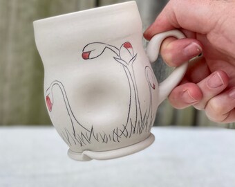 Porcelain mug with inlaid flower buds and clear and red glazes