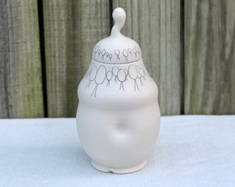 Porcelain lidded jar with inlaid whimsical tree design. Cookie jar