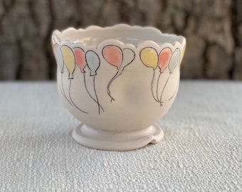 Porcelain short goblet with whimsical inlaid balloons and clear, blue, pink and yellow glazes