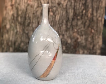 Stoneware bottle with clear glaze, inlaid sunburst design, and real 22k overglaze