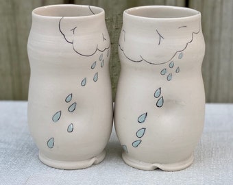 Porcelain cup with inlaid rain cloud design  and clear and blue glazes