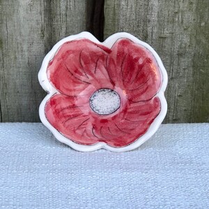 Charming ring dish with carved rim and inlaid whimsical poppy design and red and clear glaze