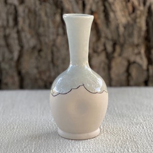 Porcelain vase with inlaid whimsical design and blue glaze