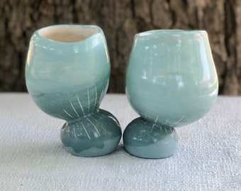 Unique Teal cup balancing on attached base with sgraffito lines and hand painted slip surface
