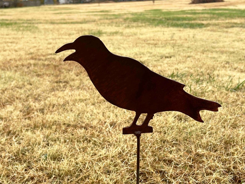 handmade metal crow garden stake - rusted steel silhouette -  9 inches long -  5 inches tall - mounted on a ground level stake