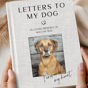 May include: A hardcover book titled "LETTERS TO MY DOG" with a photo of a dog. The book is ivory-colored with the text "IN LOVING MEMORY OF WILLOW MAE" and "Forever in my heart". The cover has a faux linen texture.