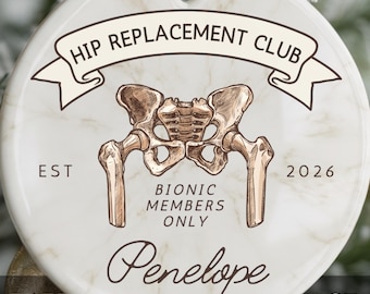 May include: A round white ceramic ornament with a marble pattern featuring a brown anatomical illustration of a human pelvis. Text reads: HIP REPLACEMENT CLUB, EST 2026, BIONIC MEMBERS ONLY, and the name Penelope in script font.