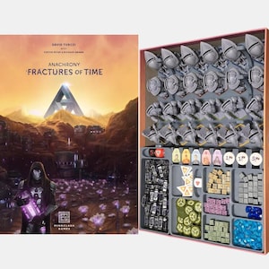 May include: Anachrony: Fractures of Time board game box set. The box art features a futuristic landscape with a figure in a hooded cloak. The open box reveals game pieces, including miniature robots and tokens, organized in gray trays.