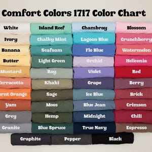 May include: A color chart titled "Comfort Colors 1717 Color Chart" displays a variety of fabric colors. The chart includes colors like white, ivory, banana, butter, mustard, terracotta, burnt orange, yam, grey, and granite.