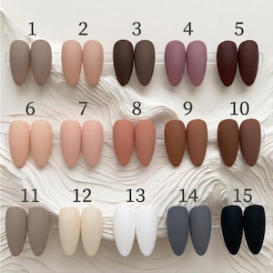 May include: A set of three ceramic mugs with a speckled, matte finish. The mugs are in shades of cream, light gray, and dark gray. Each mug has a simple, minimalist design and a rounded handle. The mugs are stacked on top of each other.