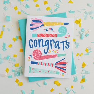 May include: A white card with a blue background and the word "congrats" written in blue cursive. The card is decorated with colorful party horns and confetti.