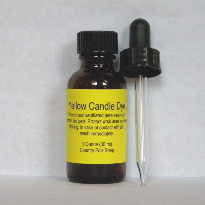 May include: A small amber glass bottle with a black dropper cap. The bottle is labeled "Yellow Candle Dye" and contains instructions for use. The bottle contains 1 ounce (30 ml) of dye. The label also says "Country Folk Soap".