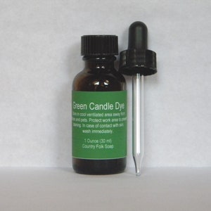 May include: A small brown glass bottle with a black dropper top. The bottle is labeled "Green Candle Dye" and contains 1 ounce (30 ml) of dye. The label also includes instructions for storage and safety.