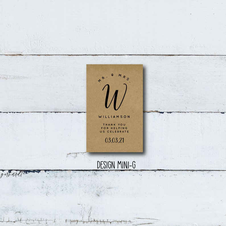 May include: A brown card with the text "Mr. & Mrs. W Williamson Thank you for helping us celebrate 03.03.21" and the design "DESIGN MINI-G" printed on it.