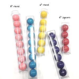 May include: Six clear plastic tubes filled with colorful candy. The tubes are labeled with the size and shape of the candy. The sizes are 4 inch, 6 inch, and 8 inch. The shapes are round and square.