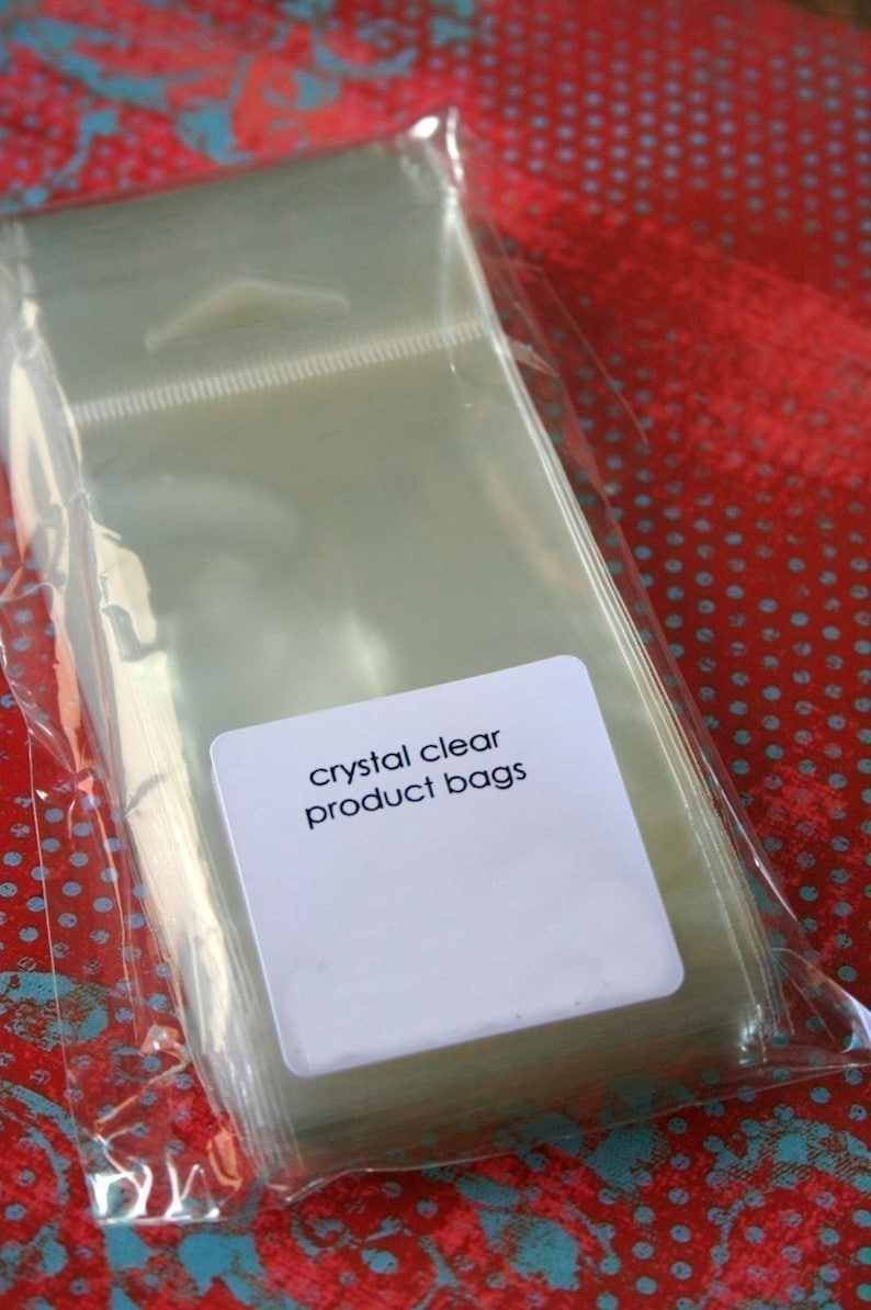 May include: A stack of clear plastic bags with a white label that reads "crystal clear product bags".