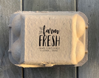 May include: A brown cardboard egg carton with a black and white sticker that says "farm fresh" and "from Lisa's girls Fischer, Texas".