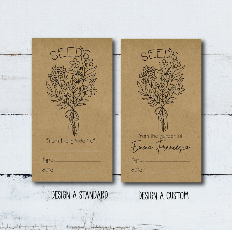 May include: Two brown paper seed packets with a black line drawing of a bouquet of flowers. The text "SEED'S" is at the top of each packet. The left packet has the text "from the garden of:" and blank lines for "type:" and "date:". The right packet has the text "from the garden of: Emma Francesca" and blank lines for "type:" and "date:". The bottom of each packet has the text "DESIGN A STANDARD" and "DESIGN A CUSTOM".