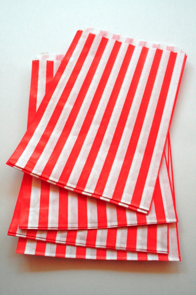 Peut inclure: Un lot de sacs en papier ray&eacute;s rouge et blanc. Les sacs sont en papier fin et de couleur rouge vif.