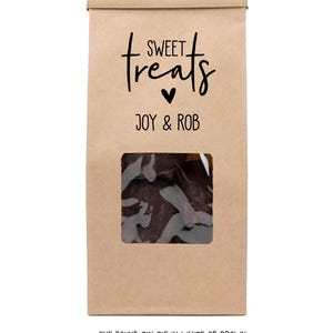 May include: Brown paper bag with a window showing chocolate treats inside. The bag has a label that says "SWEET treats" with a heart and "JOY & ROB" printed on it. The bottom of the bag says "ONE POUND TIN TIE IN WHITE OR BROWN".