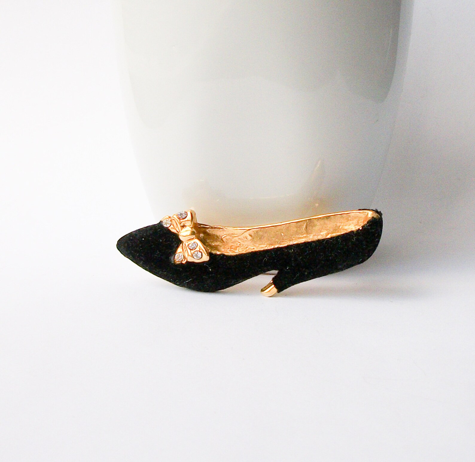 black heels with brooch