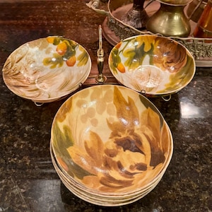 May include: A set of three ceramic mugs with a speckled, matte finish. Each mug features a different color: light blue, cream, and gray. The mugs have a simple, modern design, perfect for coffee or tea.