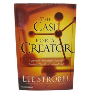 May include: A hardcover book titled "The Case for a Creator" by Lee Strobel. The cover features a molecular structure graphic in shades of yellow and brown, with the title in large, bold letters. The book is published by Zondervan.