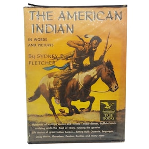 May include: Vintage book titled "The American Indian" with a yellow cover. The cover features an illustration of a Native American riding a horse. Text includes the author's name, "By Sydney E. Fletcher," and the phrase "In Words and Pictures."