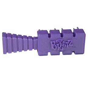 May include: A purple plastic Bratz hairbrush. The brush has a rectangular head with the Bratz logo and a ridged handle. The brush is a solid, vibrant purple color.