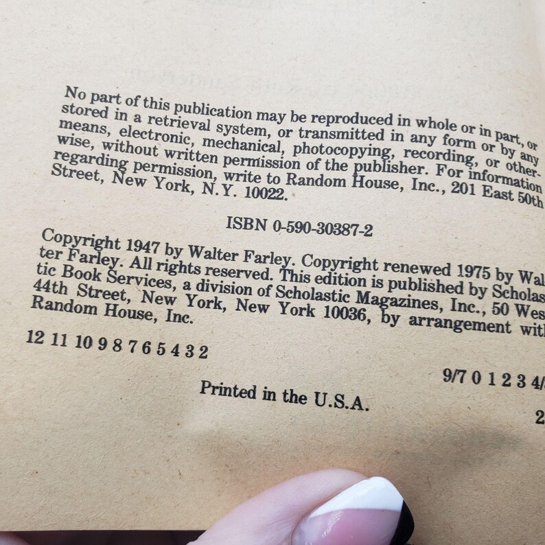 May include: A close-up of a book page with text. The page is beige and contains copyright information, an ISBN, and the phrase "Printed in the U.S.A." The text is in black and is from a 1947 publication.